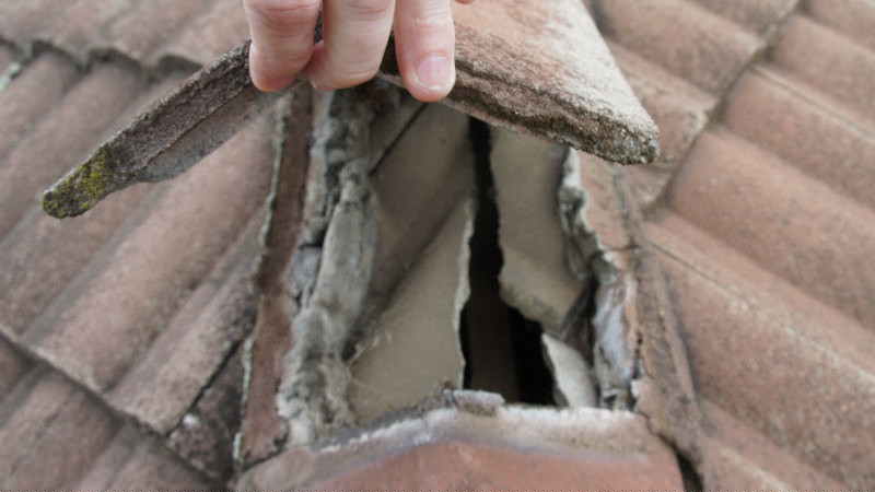 Broken ridge cap on a cement roof needing repair