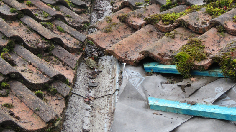 Roof valley needing replacement on a terracotta roof
