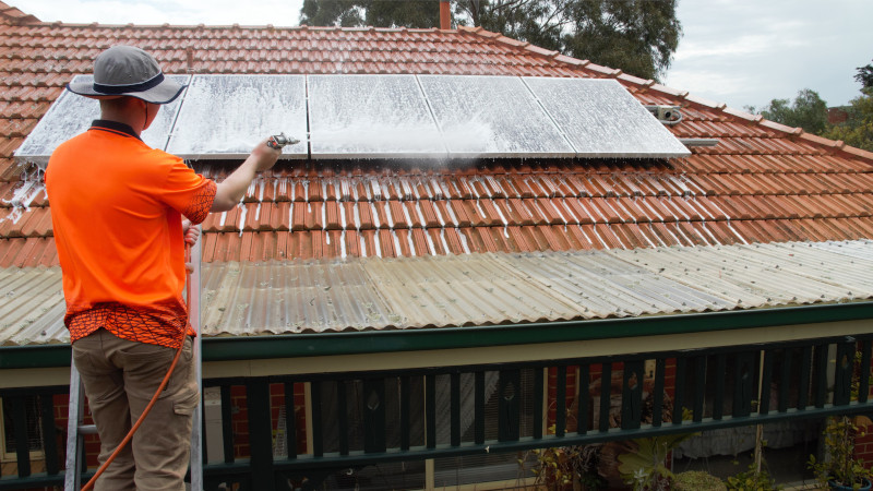 Applying Moss Roof Treatment on solar panels