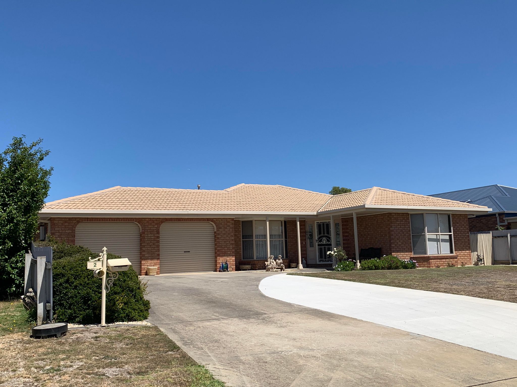 Red cement roof after moss treatment, showing clean surface