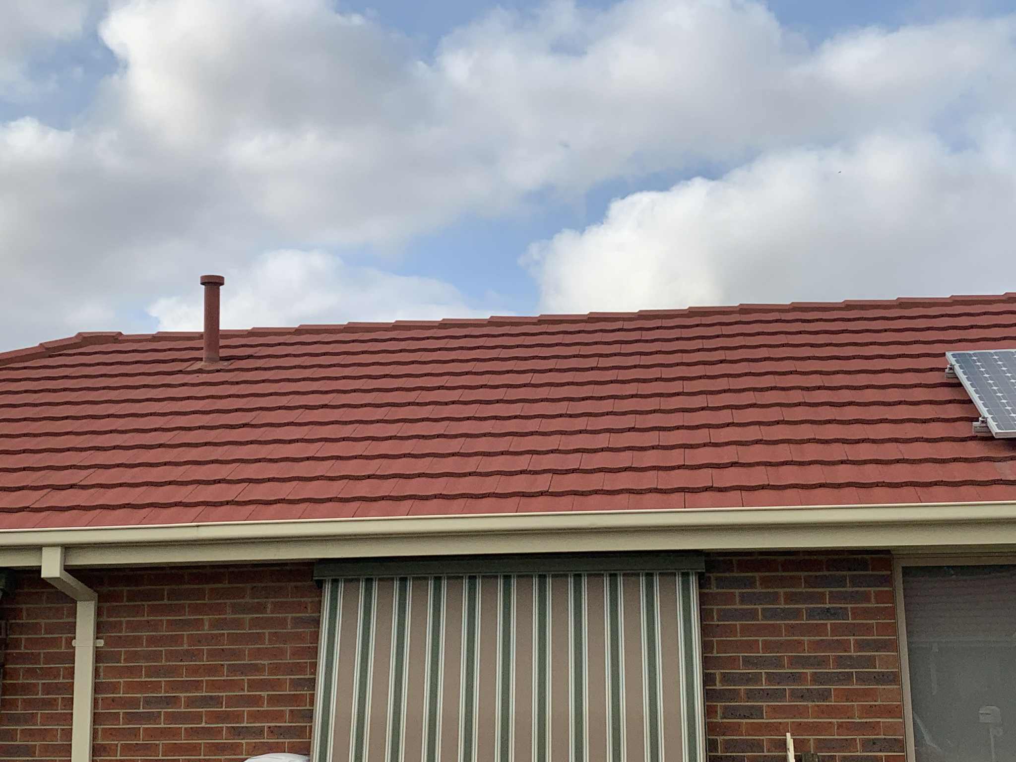 Cement roof after moss treatment, showing clean surface