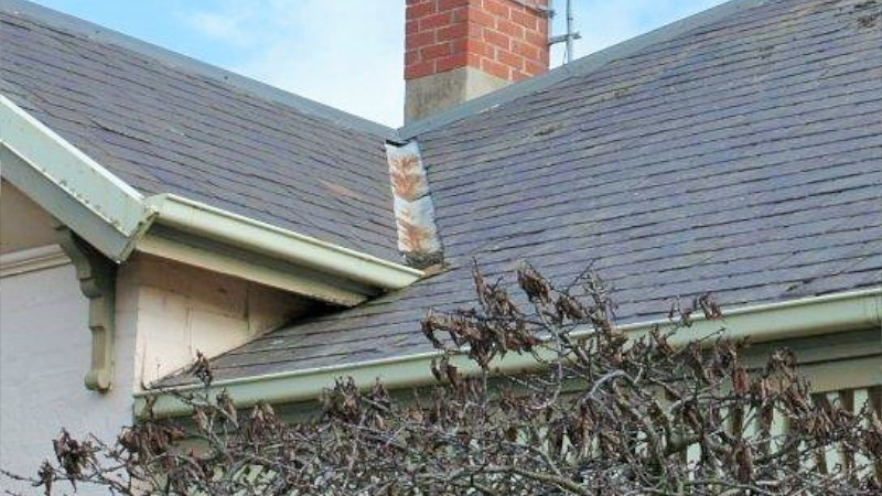 Slate roof valley after moss treatment showing a clean surface